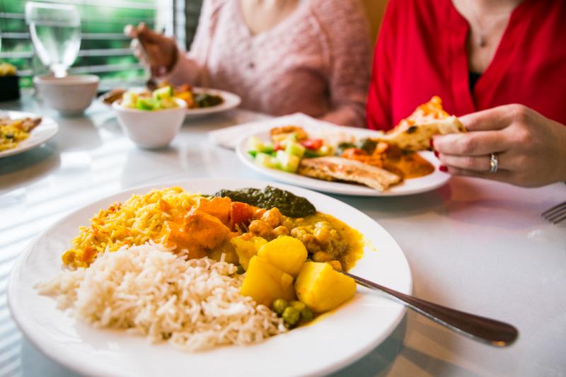 Several plates filled with authentic Indian cuisine from Taste of India