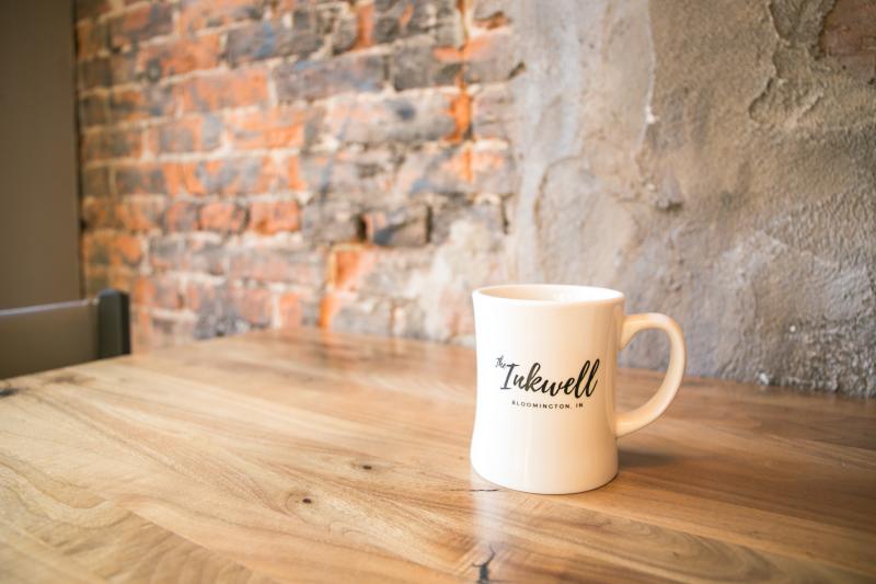 An Inkwell coffee mug sitting on a table