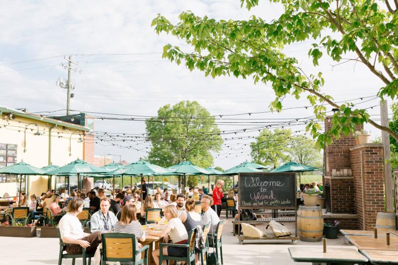 People dining on the patio at Upland