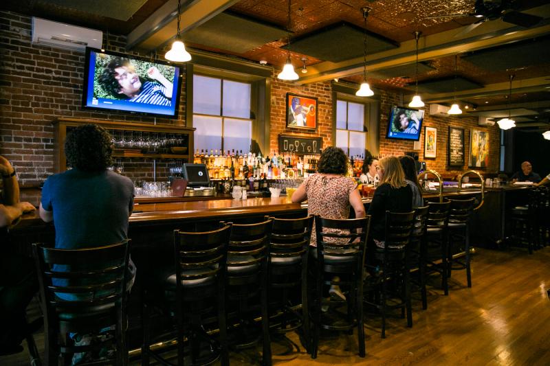 People dining at the bar at Uptown Cafe