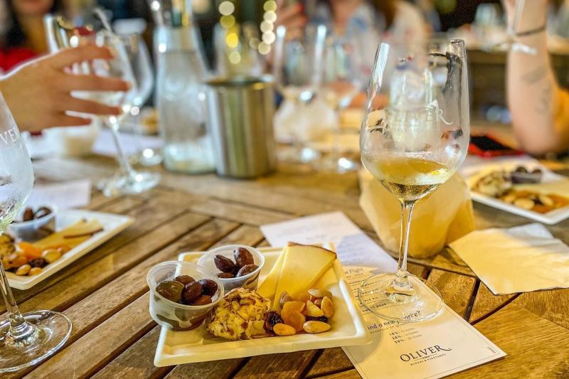 A table of women enjoying wine and charcuterie plates at Oliver Winery