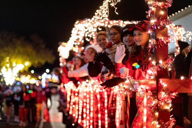 Photo of children smiling and waving on a lighted parade float during the Christmas Parade in downtown Brownwood.