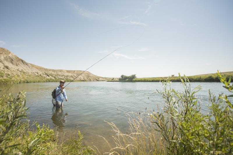 A man fishing in the water at North Platte River