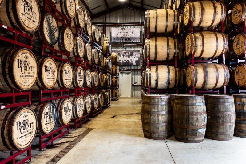 Stacks of bourbon barrels held in red shelves at Boone County Distilling Co.