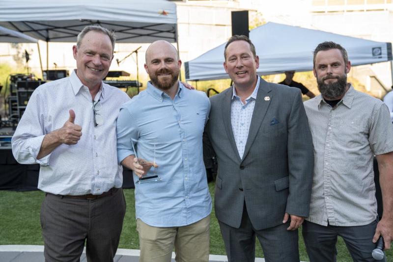Chef Matt Finley poses with award and three men for his recognition as chef of the year.