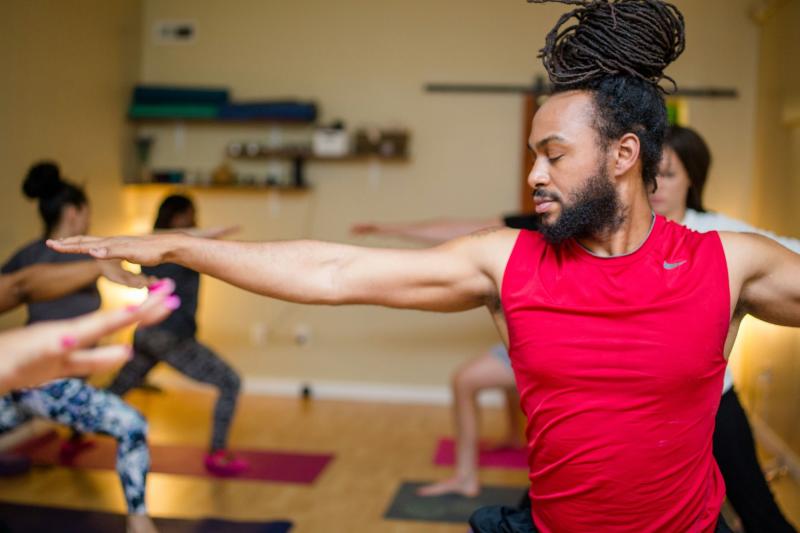 Man teaching yoga class