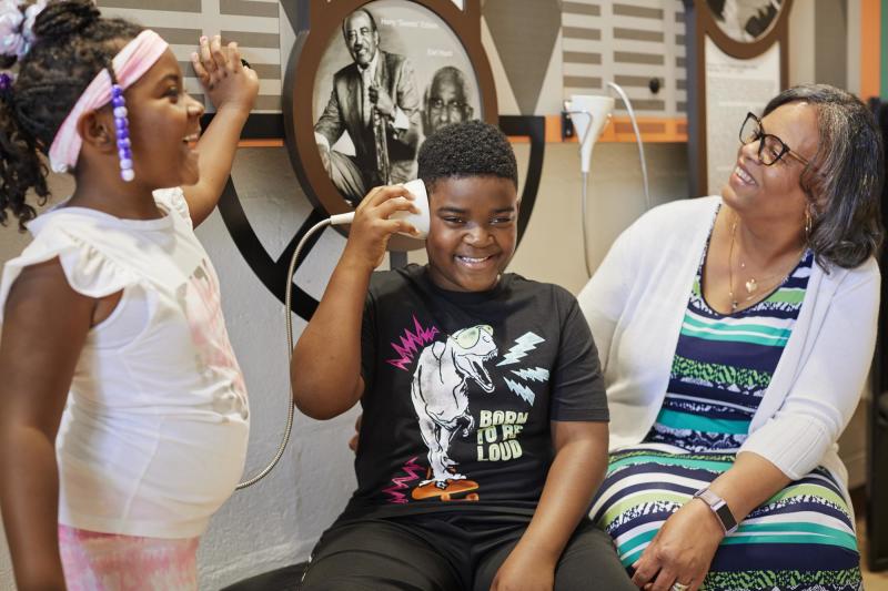 Black family of three smiling and laughing
