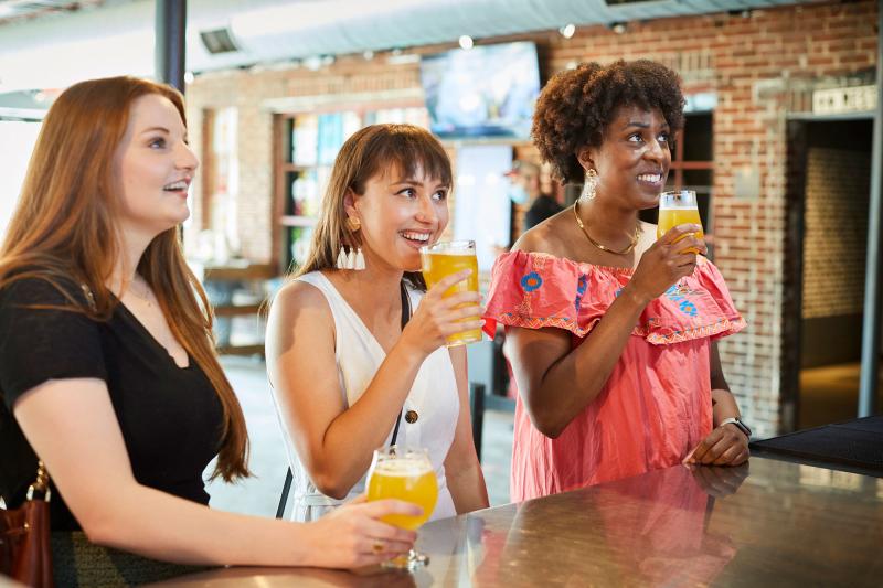 Group of girls enjoying beer at Land-Grant Brewing Company