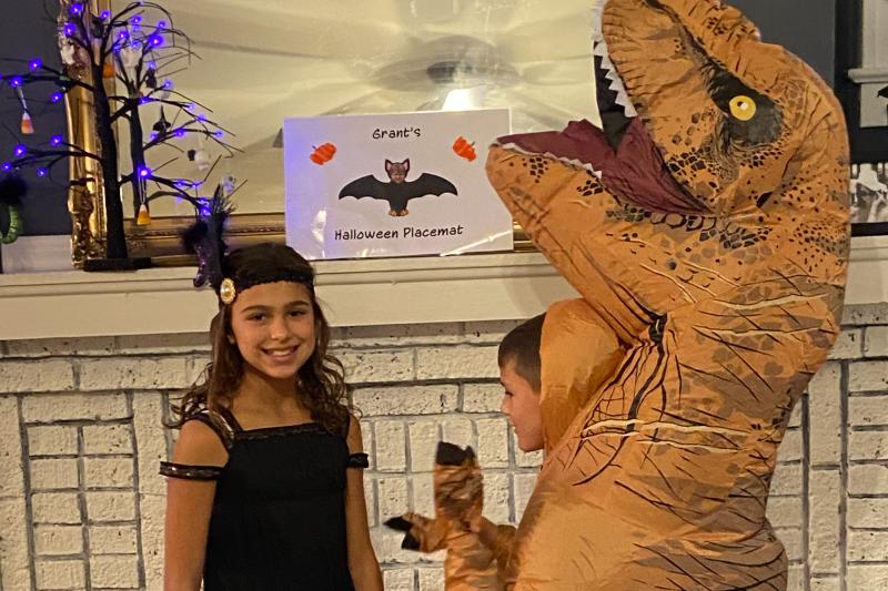 Kids dressed as a flapper and a dinosaur