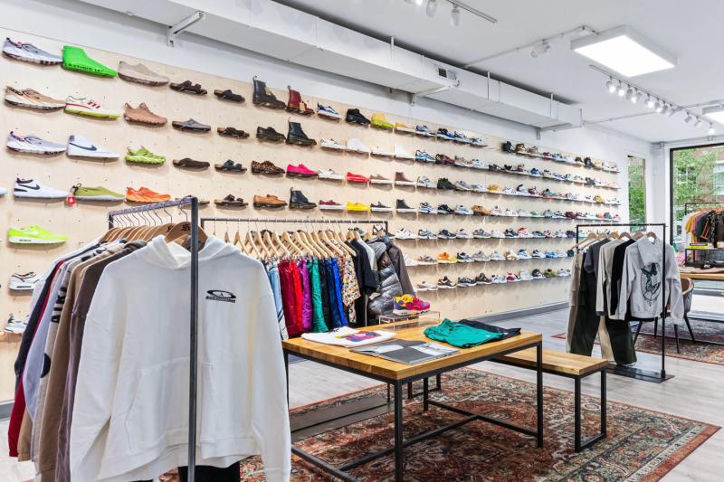 Wall of shoes and clothing racks