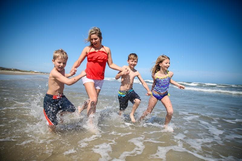 Beach Rules - Family playing in waves