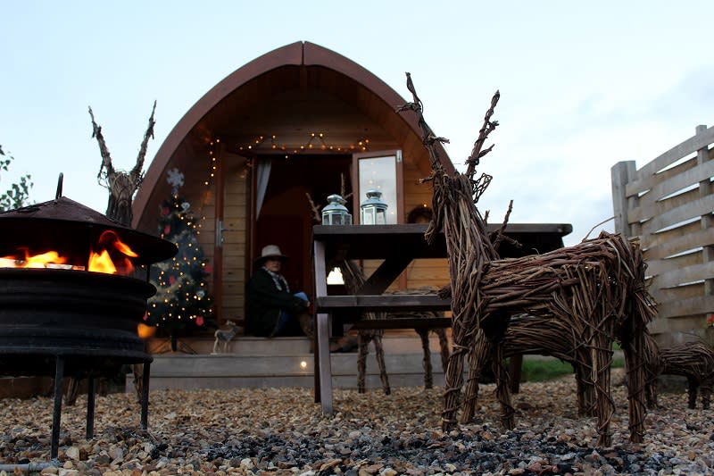 Wicker reindeer decorate the outside space of a glamping pod at Notgrove Holidays