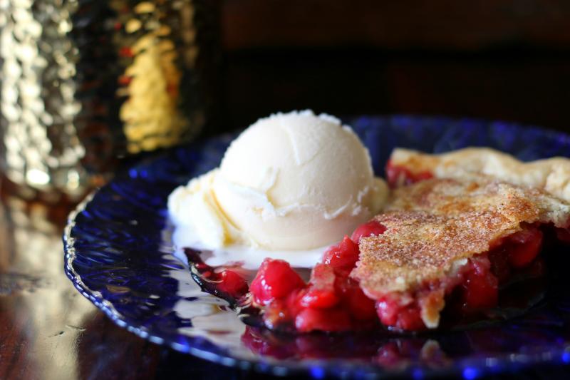 Cherry Pie with Vanilla Ice Cream on a blue, ceramic plate