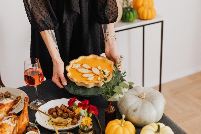 Woman Serving Pumpkin Pie at Thanksgiving