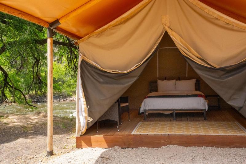 A canvas tent by the Poudre River.