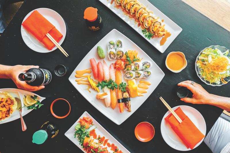 The top view of a table full of a selection of sushi dishes