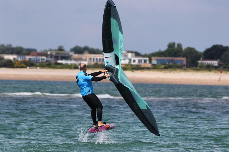 A person wing foiling on the sea