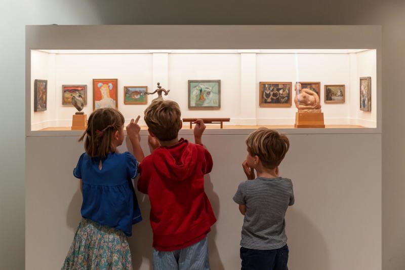 Children looking at miniature pieces of art at Pallant House