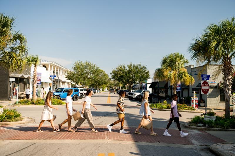 Teens crossing road down Reid Ave