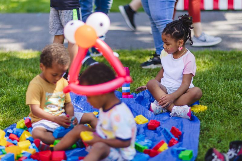three kids playing with blocks at the kidsfest during Artsfest in Harrisburg, PA.