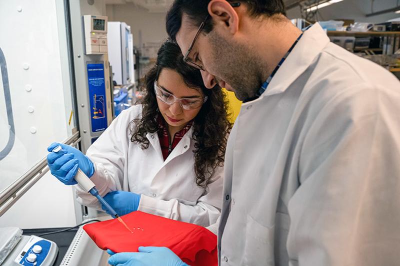 UBC Okanagan researchers Sadaf Shabanian (left) and Kevin Golovin (right) test water-repellent fabric treatment