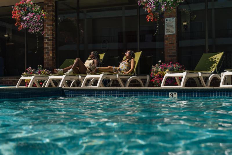 People Relaxing at Coast Capri Hotel Pool
