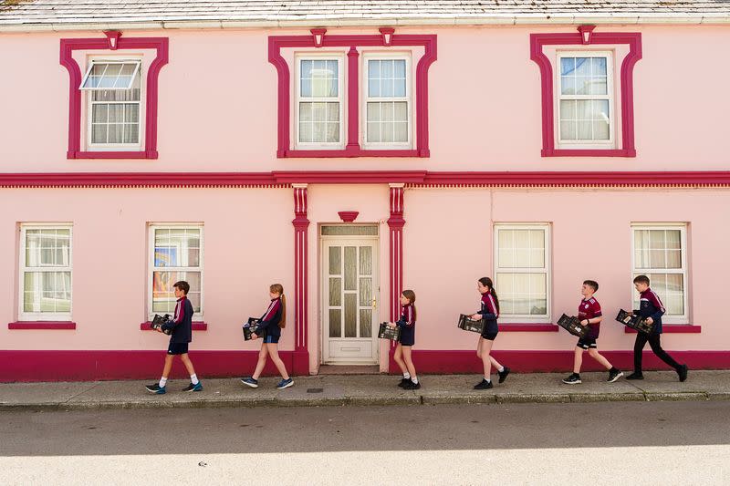 Knocknagoshel School Students Walking Footpath with Grocery Boxes