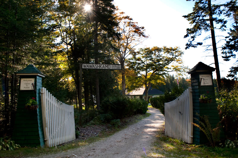 A dirt path leads through the gate to the historic grounds of Mackinac Island’s Wawashkamo Golf Club