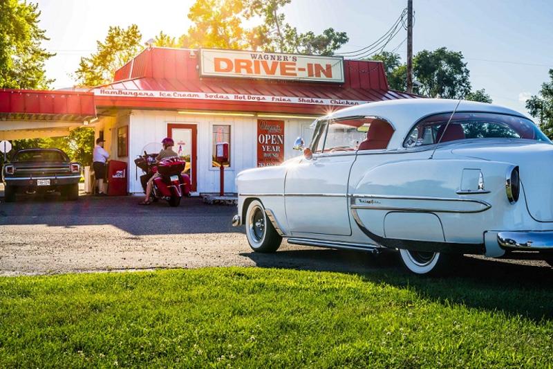 A classic car sits parked outside Wagner's Drive-In