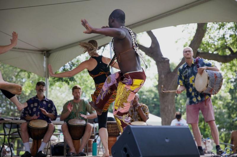 Dance troupe dancing to drummers during a Performance at Twin Cities World Refugee Day