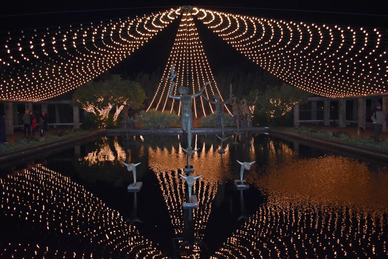 String lights reflect on the water during Brookgreen Gardens Nights of a Thousand Candles, Visit Myrtle Beach, SC