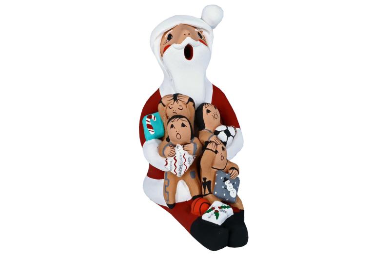 Storyteller Santa holding four children by artist Diane Lucero.