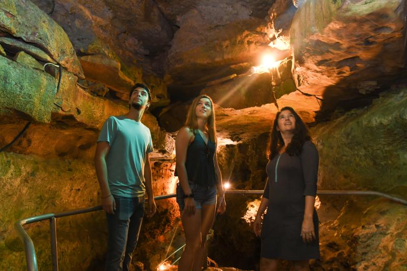 Family gaze at the rock formations in Wonder World Cave in San Marcos, Texas