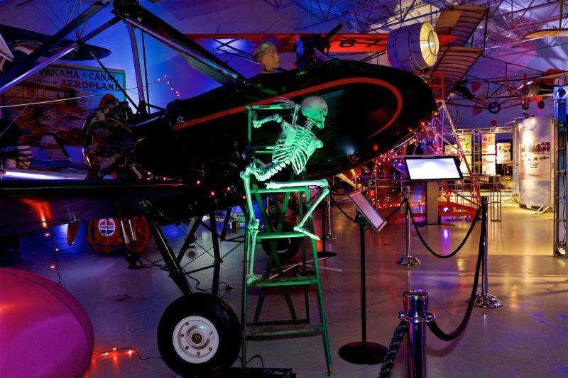 A skeleton hangs off an airplane at Hiller Aviation Museum