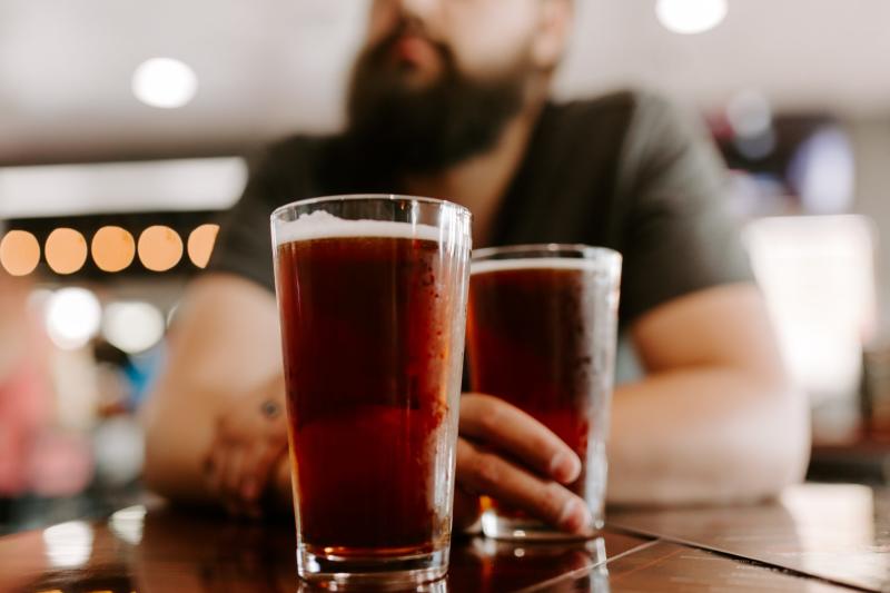 Man enjoying a glass of beer at a local brewery