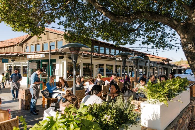 People gathered on outdoor patio at Wildseed