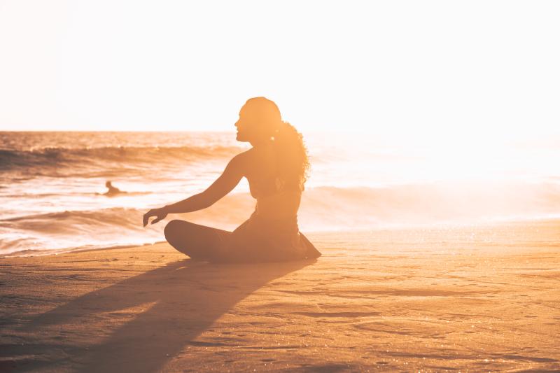 Woman-hanging-out-at-the-beach-admiring-the-sunset