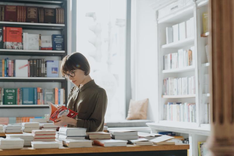 Woman checking out a book at a book store