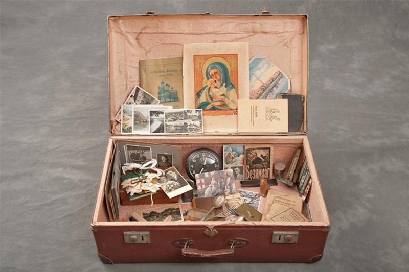 old brown suitcase filled with old belongings