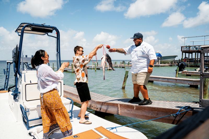 Couple bringing caught fish to cook