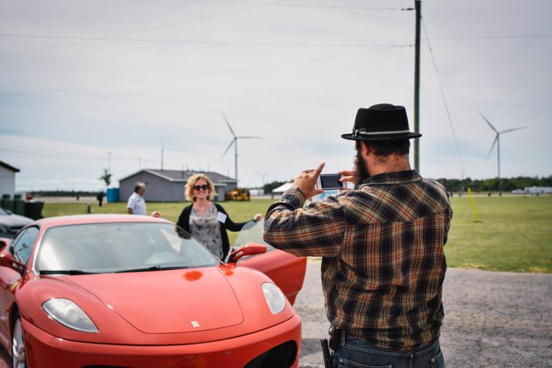 Man taking photo of exotic car