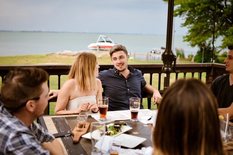 group on patio eating near waterfront