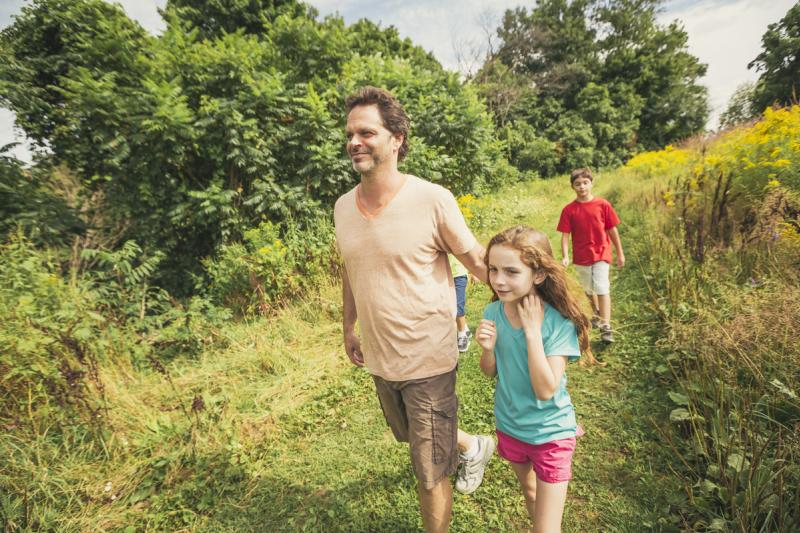 family hiking on trail