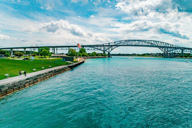 two people cycling on waterside trail in sarnia