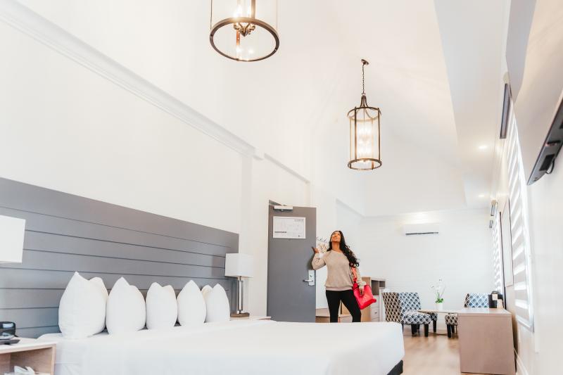 woman walking into hotel room