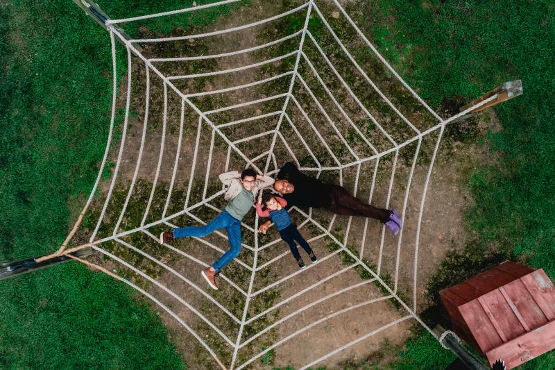 Family laying on net hammock