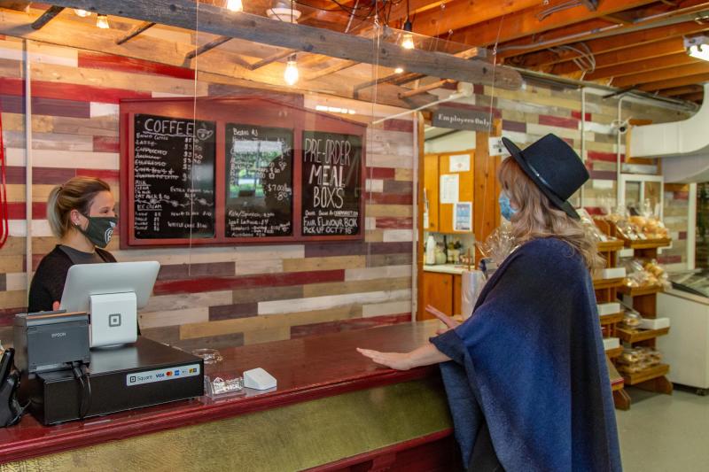 woman purchasing coffee with mask