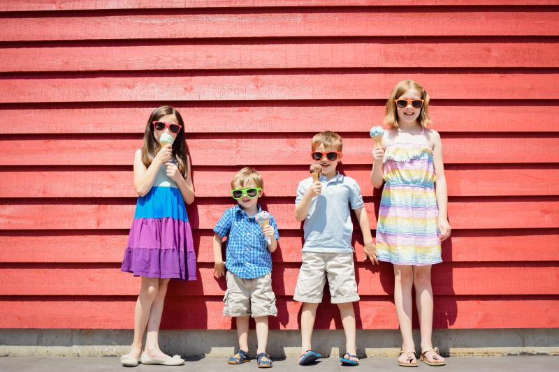 4 kids eating ice cream looking at camera
