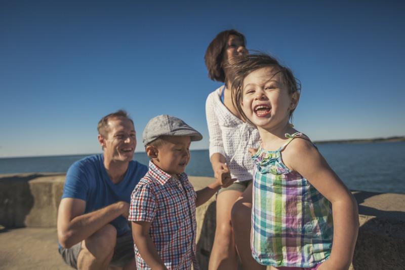 family on pier by water