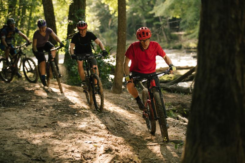 3 cyclists on a bike trail